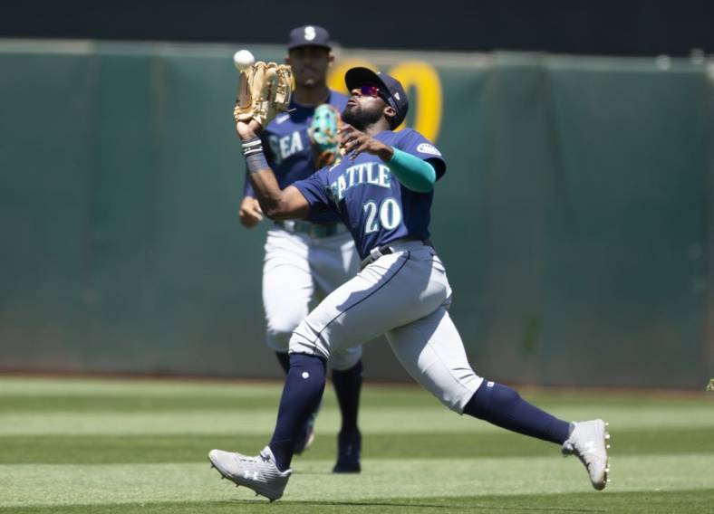 Jun 23, 2022; Oakland, California, USA; Seattle Mariners right fielder Taylor Trammell (20) makes a running catch of a fly ball by Oakland Athletics second baseman Jonah Bride (not pictured) during the fifth inning at RingCentral Coliseum. Mandatory Credit: D. Ross Cameron-USA TODAY Sports