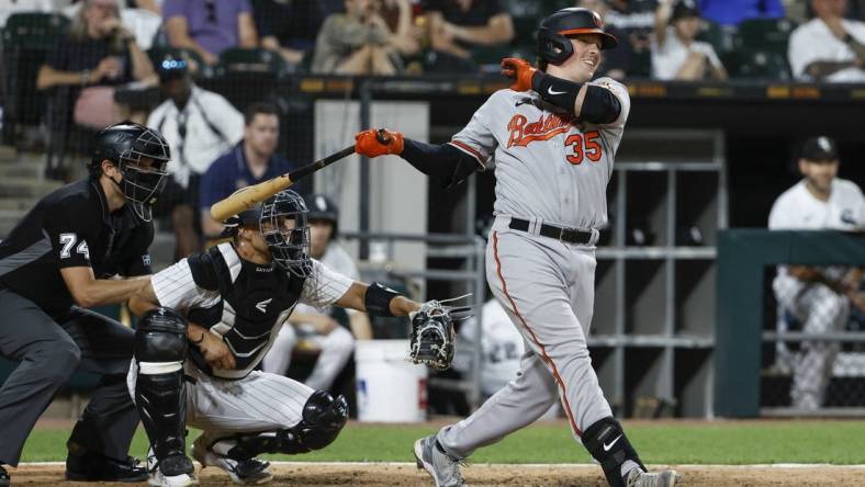 Jun 23, 2022; Chicago, Illinois, USA; Baltimore Orioles designated hitter Adley Rutschman (35) hits an RBI-double against the Chicago White Sox during the sixth inning at Guaranteed Rate Field. Mandatory Credit: Kamil Krzaczynski-USA TODAY Sports