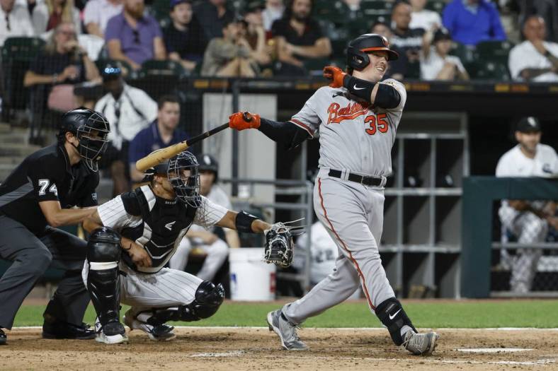 Jun 23, 2022; Chicago, Illinois, USA; Baltimore Orioles designated hitter Adley Rutschman (35) hits an RBI-double against the Chicago White Sox during the sixth inning at Guaranteed Rate Field. Mandatory Credit: Kamil Krzaczynski-USA TODAY Sports