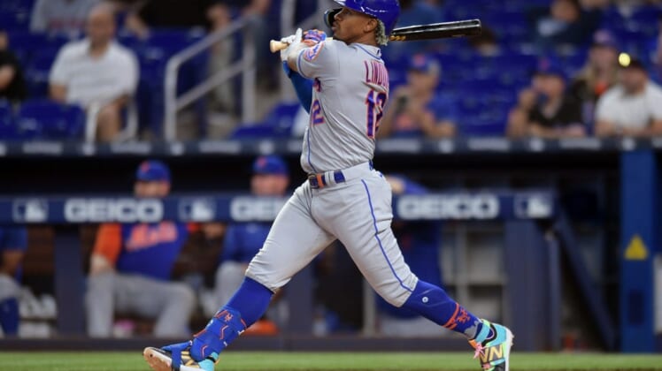 Jun 24, 2022; Miami, Florida, USA; New York Mets shortstop Francisco Lindor (12) hits a home run in the first inning against the Miami Marlins at loanDepot Park. Mandatory Credit: Jim Rassol-USA TODAY Sports