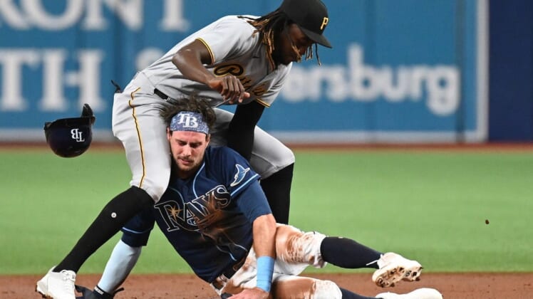 Jun 24, 2022; St. Petersburg, Florida, USA; Pittsburg Pirates shortstop Oneil Cruz (15) and Tampa Bay Rays right fielder Josh Lowe (15) collide on a steal attempt in the second inning at Tropicana Field. Mandatory Credit: Jonathan Dyer-USA TODAY Sports