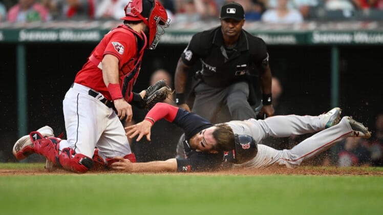 Jun 24, 2022; Cleveland, Ohio, USA; Cleveland Guardians catcher Austin Hedges (17) tags out Boston Red Sox shortstop Christian Arroyo (39) during the fifth inning at Progressive Field. Mandatory Credit: Ken Blaze-USA TODAY Sports