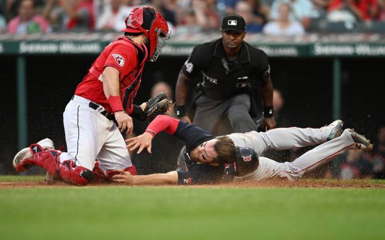 Jun 24, 2022; Cleveland, Ohio, USA; Cleveland Guardians catcher Austin Hedges (17) tags out Boston Red Sox shortstop Christian Arroyo (39) during the fifth inning at Progressive Field. Mandatory Credit: Ken Blaze-USA TODAY Sports
