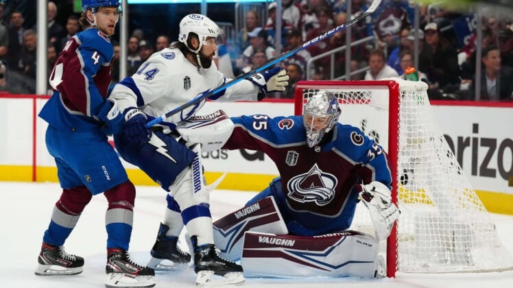 Jun 24, 2022; Denver, Colorado, USA; Colorado Avalanche defenseman Bowen Byram (4) helps goaltender Darcy Kuemper (35) defend the goal against Tampa Bay Lightning left wing Pat Maroon (14) during the first period in game five of the 2022 Stanley Cup Final at Ball Arena. Mandatory Credit: Ron Chenoy-USA TODAY Sports
