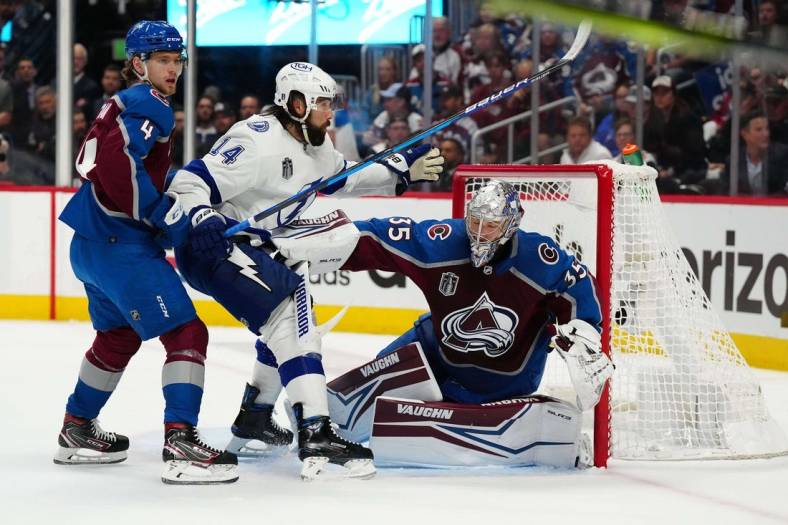 Jun 24, 2022; Denver, Colorado, USA; Colorado Avalanche defenseman Bowen Byram (4) helps goaltender Darcy Kuemper (35) defend the goal against Tampa Bay Lightning left wing Pat Maroon (14) during the first period in game five of the 2022 Stanley Cup Final at Ball Arena. Mandatory Credit: Ron Chenoy-USA TODAY Sports