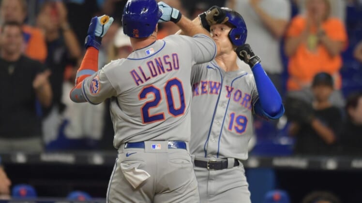 Jun 25, 2022; Miami, Florida, USA; New York Mets first baseman Pete Alonso (20) celebrates a home run with left fielder Mark Canha (19) in the second inning against the Miami Marlins at loanDepot Park. Mandatory Credit: Jim Rassol-USA TODAY Sports