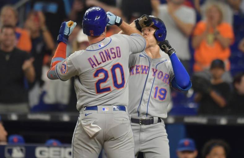 Jun 25, 2022; Miami, Florida, USA; New York Mets first baseman Pete Alonso (20) celebrates a home run with left fielder Mark Canha (19) in the second inning against the Miami Marlins at loanDepot Park. Mandatory Credit: Jim Rassol-USA TODAY Sports