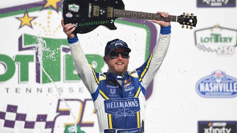 Jun 25, 2022; Nashville, Tennessee, USA; NASCAR Xfinity Series driver Justin Allgaier (7) celebrates in victory lane after winning the Xfinity Tennessee Lottery 250 at Nashville Superspeedway. Mandatory Credit: Christopher Hanewinckel-USA TODAY Sports