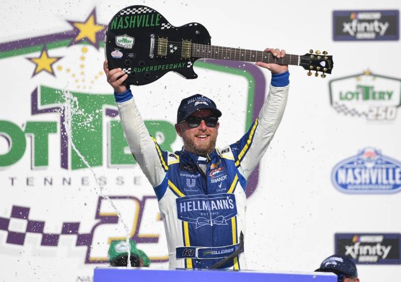 Jun 25, 2022; Nashville, Tennessee, USA; NASCAR Xfinity Series driver Justin Allgaier (7) celebrates in victory lane after winning the Xfinity Tennessee Lottery 250 at Nashville Superspeedway. Mandatory Credit: Christopher Hanewinckel-USA TODAY Sports
