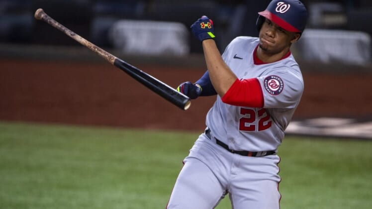 Jun 25, 2022; Arlington, Texas, USA; Washington Nationals right fielder Juan Soto (22) tosses his bat after he strikes out with runners in scoring position to end the seventh inning against the Texas Rangers at Globe Life Field. Mandatory Credit: Jerome Miron-USA TODAY Sports