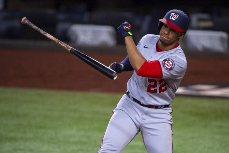 Jun 25, 2022; Arlington, Texas, USA; Washington Nationals right fielder Juan Soto (22) tosses his bat after he strikes out with runners in scoring position to end the seventh inning against the Texas Rangers at Globe Life Field. Mandatory Credit: Jerome Miron-USA TODAY Sports