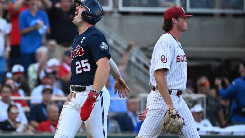 Jun 25, 2022; Omaha, NE, USA;  Ole Miss Rebels first baseman Tim Elko (25) scores against the Oklahoma Sooners during the first inning at Charles Schwab Field. Mandatory Credit: Steven Branscombe-USA TODAY Sports