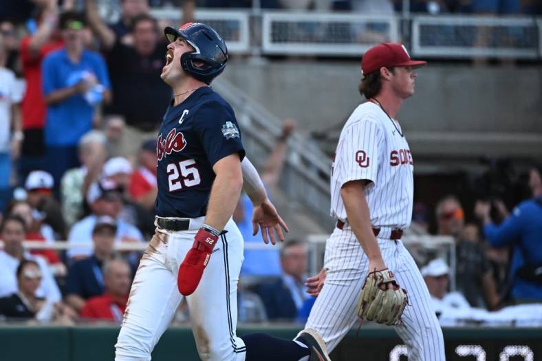 Jun 25, 2022; Omaha, NE, USA;  Ole Miss Rebels first baseman Tim Elko (25) scores against the Oklahoma Sooners during the first inning at Charles Schwab Field. Mandatory Credit: Steven Branscombe-USA TODAY Sports