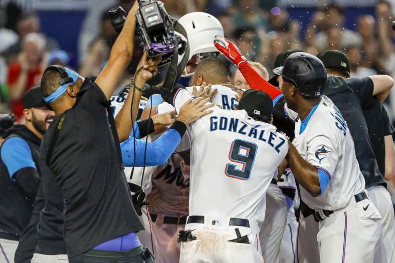 Jun 26, 2022; Miami, Florida, USA; Miami Marlins celebrate at home plate after a walk-off home run by catcher Nick Fortes (54) in the ninth inning against the New York Mets at loanDepot Park. Mandatory Credit: Sam Navarro-USA TODAY Sports
