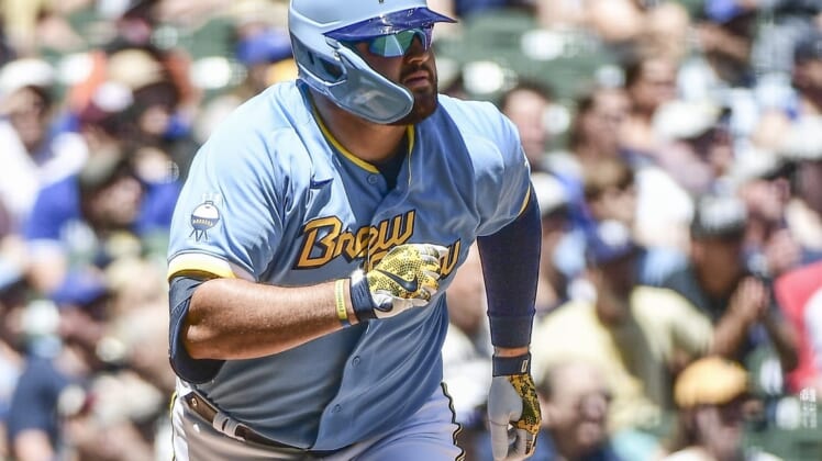 Jun 26, 2022; Milwaukee, Wisconsin, USA;  Milwaukee Brewers first baseman Rowdy Tellez (11) watches after hitting a two-run home run in the second inning during game against the Toronto Blue Jays at American Family Field. Mandatory Credit: Benny Sieu-USA TODAY Sports