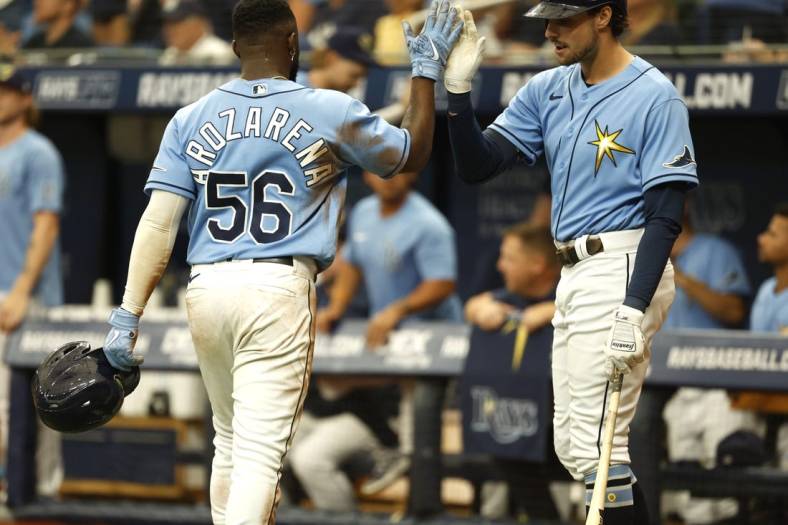 Jun 26, 2022; St. Petersburg, Florida, USA;  Tampa Bay Rays right fielder Randy Arozarena (56) is congratulated by  center fielder Josh Lowe (15) after he scores a run against the Pittsburgh Pirates during the seventh inning at Tropicana Field. Mandatory Credit: Kim Klement-USA TODAY Sports