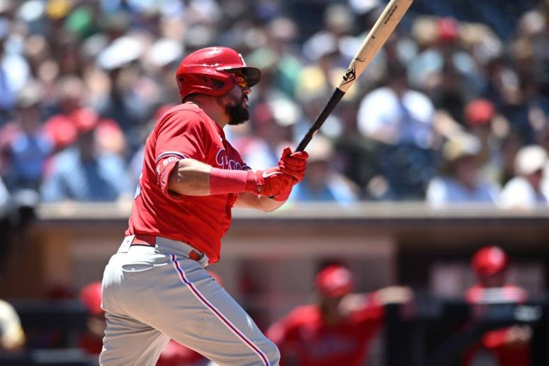 Jun 26, 2022; San Diego, California, USA; Philadelphia Phillies left fielder Kyle Schwarber (12) hits an RBI double during the second inning against the San Diego Padres at Petco Park. Mandatory Credit: Orlando Ramirez-USA TODAY Sports