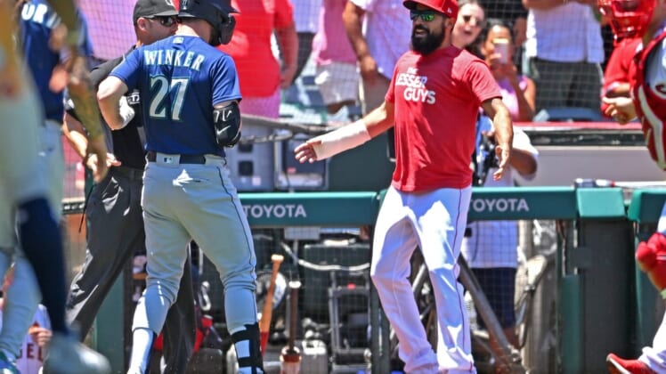Jun 26, 2022; Anaheim, California, USA;  Seattle Mariners right fielder Jesse Winker (27) engages with Los Angeles Angels Anthony Rendon (6) during a benches clearing brawl in the second inning at Angel Stadium. Mandatory Credit: Jayne Kamin-Oncea-USA TODAY Sports