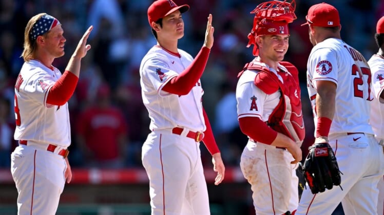 Jun 26, 2022; Anaheim, California, USA;  Los Angeles Angels first baseman David MacKinnon (39) designated hitter Shohei Ohtani (17) and catcher Max Stassi (33) high five center fielder Mike Trout (27) after the final out of the ninth inning defeating the Seattle Mariners at Angel Stadium. Mandatory Credit: Jayne Kamin-Oncea-USA TODAY Sports