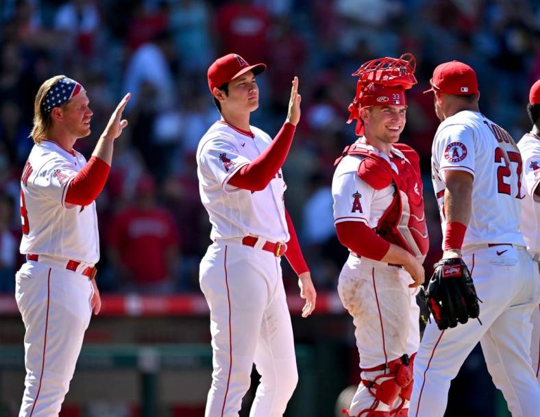 Jun 26, 2022; Anaheim, California, USA;  Los Angeles Angels first baseman David MacKinnon (39) designated hitter Shohei Ohtani (17) and catcher Max Stassi (33) high five center fielder Mike Trout (27) after the final out of the ninth inning defeating the Seattle Mariners at Angel Stadium. Mandatory Credit: Jayne Kamin-Oncea-USA TODAY Sports