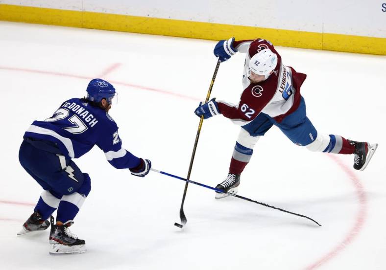 Jun 26, 2022; Tampa, Florida, USA; Colorado Avalanche left wing Artturi Lehkonen (62) shoots the puck against Tampa Bay Lightning defenseman Victor Hedman (77) during the second period in game six of the 2022 Stanley Cup Final at Amalie Arena. Mandatory Credit: Mark J. Rebilas-USA TODAY Sports