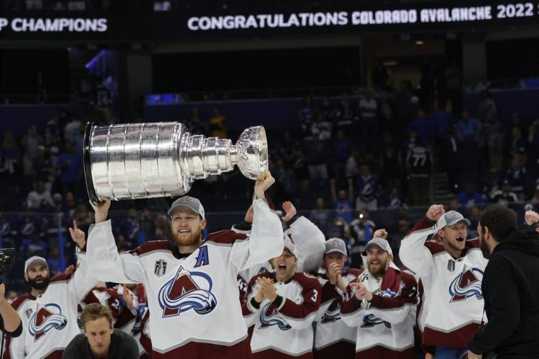 Jun 26, 2022; Tampa, Florida, USA; Colorado Avalanche center Nathan MacKinnon (29) celebrates with the Stanley Cup after the Avalanche game against the Tampa Bay Lightning in game six of the 2022 Stanley Cup Final at Amalie Arena. Mandatory Credit: Geoff Burke-USA TODAY Sports