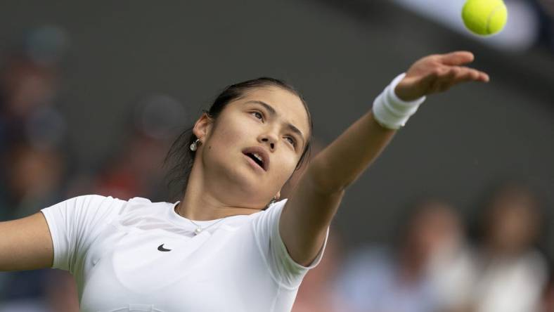 Jun 27, 2022; London, United Kingdom;  Emma Raducanu (GBR) tosses the ball to serve during her first round match against Alison Van Uytvanck (BEL) on day one at All England Lawn Tennis and Croquet Club. Mandatory Credit: Susan Mullane-USA TODAY Sports