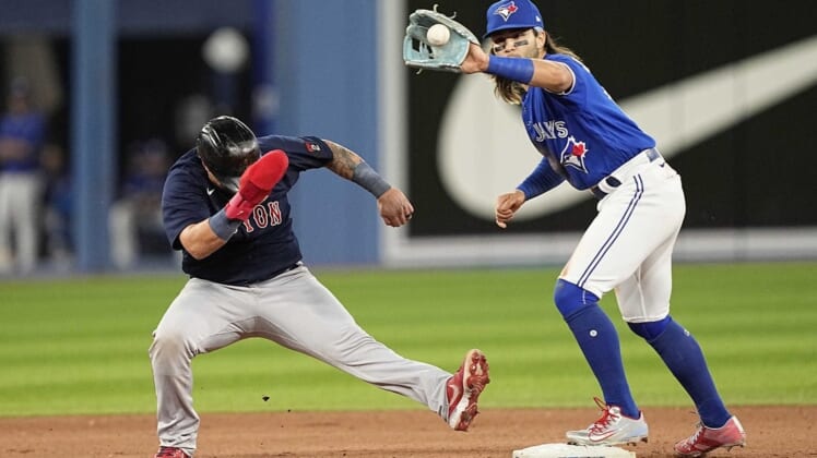 Jun 27, 2022; Toronto, Ontario, CAN; Boston Red Sox catcher Christian Vazquez (7) goes back to second against Toronto Blue Jays shortstop Bo Bichette (11) can make a tag during the seventh inning at Rogers Centre. Mandatory Credit: John E. Sokolowski-USA TODAY Sports