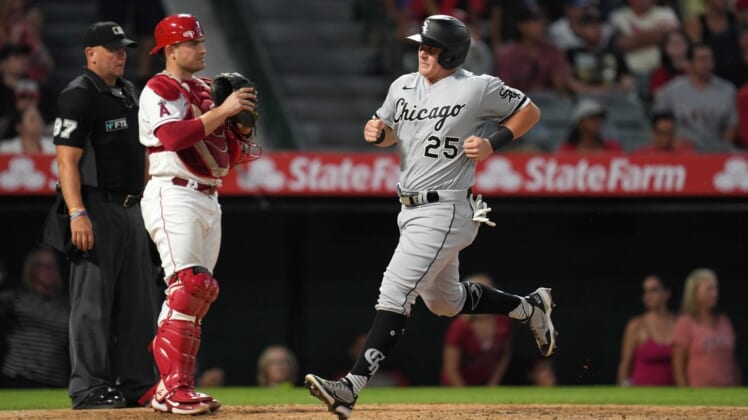 Jun 27, 2022; Anaheim, California, USA; Chicago White Sox designated hitter Andrew Vaughn (25) crosses home plate to score in the sixth inning as Los Angeles Angels catcher Max Stassi (33) watches at Angel Stadium. Mandatory Credit: Kirby Lee-USA TODAY Sports