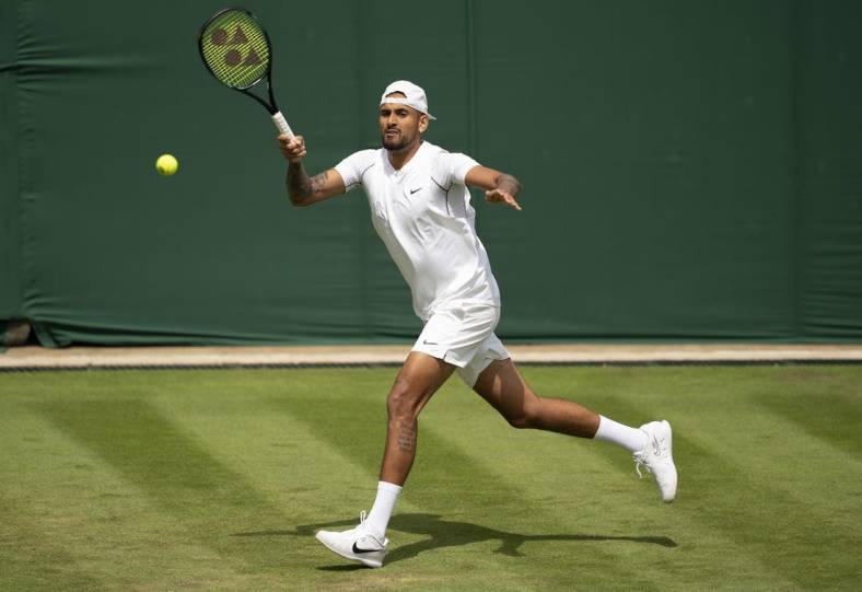 Jun 28, 2022; London, United Kingdom; Nick Kyrgios (AUS) returns a shot during her first round match against Paul Jubb (GBR) on day two at All England Lawn Tennis and Croquet Club. Mandatory Credit: Susan Mullane-USA TODAY Sports