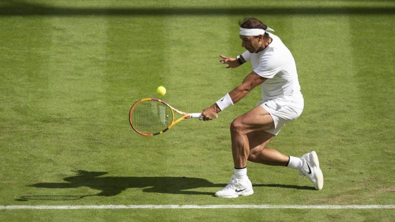 Jun 28, 2022; London, United Kingdom; Rafael Nadal (ESP) returns a shot during his first round match against Francisco Cerundolo (ARG) on day two at All England Lawn Tennis and Croquet Club. Mandatory Credit: Susan Mullane-USA TODAY Sports