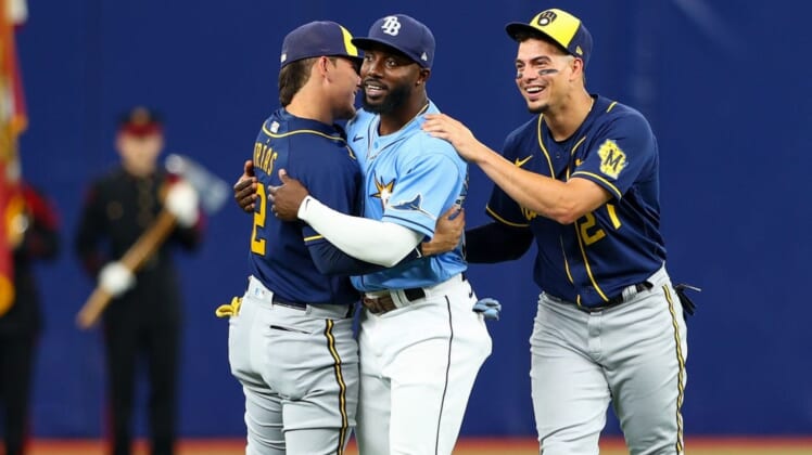 Jun 28, 2022; St. Petersburg, Florida, USA;  Tampa Bay Rays left fielder Randy Arozarena (56) is greeted by Milwaukee Brewers shortstop Willy Adames (27) and shortstop Luis Urias (2) before a game at Tropicana Field. Mandatory Credit: Nathan Ray Seebeck-USA TODAY Sports