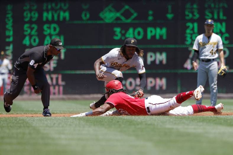 Jun 29, 2022; Washington, District of Columbia, USA; Washington Nationals first baseman Josh Bell (19) slides into second base for a double ahead of the tag of Pittsburgh Pirates shortstop Oneil Cruz (15) during the first inning at Nationals Park. Mandatory Credit: Geoff Burke-USA TODAY Sports