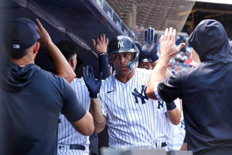 Jun 29, 2022; Bronx, New York, USA;New York Yankees designated hitter Giancarlo Stanton (27) celebrates with teammates after hitting a three run home run during the third inning against the Oakland Athletics at Yankee Stadium. Mandatory Credit: Vincent Carchietta-USA TODAY Sports