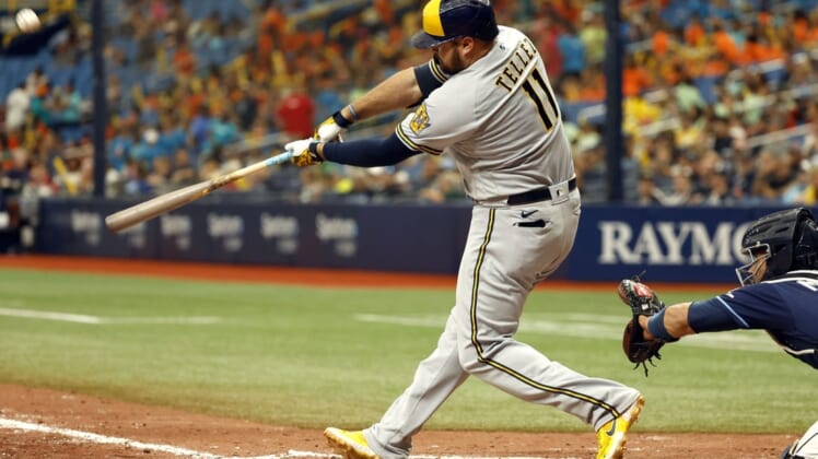 Jun 29, 2022; St. Petersburg, Florida, USA;Milwaukee Brewers first baseman Rowdy Tellez (11) hits the go-ahead home run against the Tampa Bay Rays during the eighth inning at Tropicana Field. Mandatory Credit: Kim Klement-USA TODAY Sports