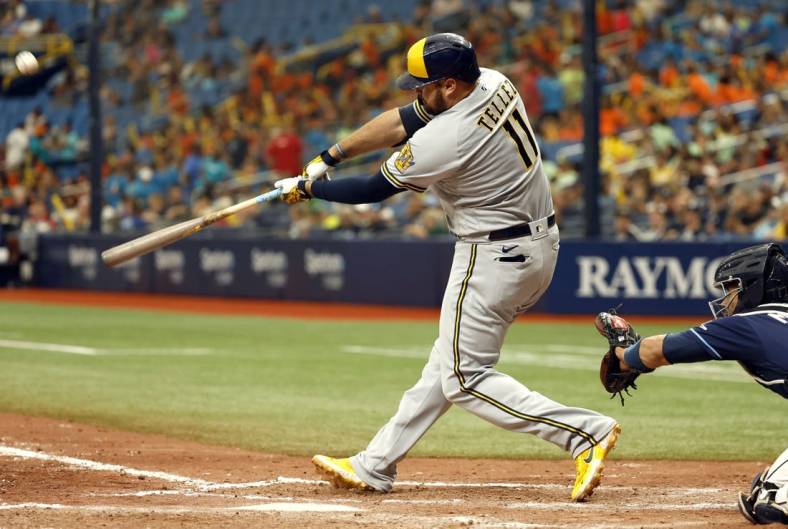 Jun 29, 2022; St. Petersburg, Florida, USA;Milwaukee Brewers first baseman Rowdy Tellez (11) hits the go-ahead home run against the Tampa Bay Rays during the eighth inning at Tropicana Field. Mandatory Credit: Kim Klement-USA TODAY Sports
