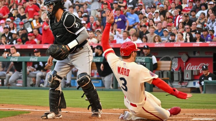 Jun 29, 2022; Anaheim, California, USA; Los Los Angeles Angels right fielder Taylor Ward (3) scores past Chicago White Sox catcher Reese McGuire (21) on a double hit by Los Angeles Angels center fielder Mike Trout (not pictured) in the first inning at Angel Stadium. Mandatory Credit: Jayne Kamin-Oncea-USA TODAY Sports