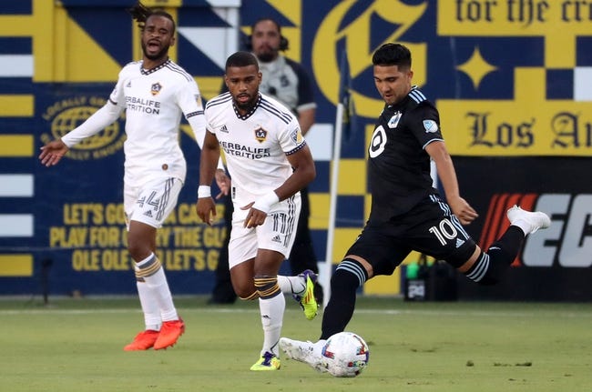 Jun 29, 2022; Carson, California, USA;  Minnesota United FC midfielder Emanuel Reynoso (10) scores a goal during the first half against the Los Angeles Galaxy at Dignity Health Sports Park. Mandatory Credit: Kiyoshi Mio-USA TODAY Sports