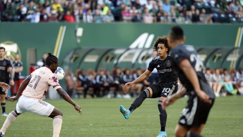 Jun 29, 2022; Portland, Oregon, USA; Houston Dynamo midfielder Adalberto Carrasquilla (20) takes a shot on goal against Portland Timbers midfielder Diego Chara (21) during the first half at Providence Park. Mandatory Credit: Soobum Im-USA TODAY Sports