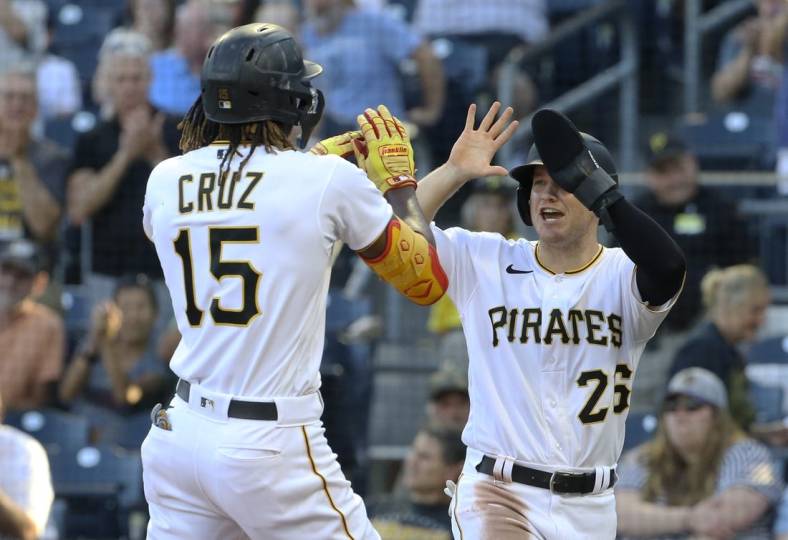 Jun 30, 2022; Pittsburgh, Pennsylvania, USA; Pittsburgh Pirates first baseman Josh VanMeter (right) congratulates shortstop Oneil Cruz (15) on his two-run home run against the Milwaukee Brewers during the second inning at PNC Park. Mandatory Credit: Charles LeClaire-USA TODAY Sports