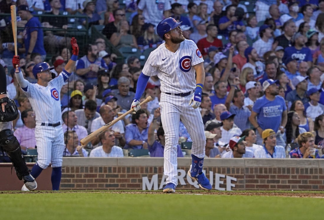 Jun 30, 2022; Chicago, Illinois, USA; Chicago Cubs third baseman Patrick Wisdom (16) watches his grand slam home run against the Cincinnati Reds during the second inning at Wrigley Field. Mandatory Credit: David Banks-USA TODAY Sports