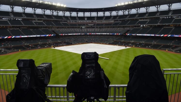 Jul 31, 2018; Atlanta, GA, USA; Television cameras are covered up during a rain delay prior to the game against the Atlanta Braves and the Miami Marlins at SunTrust Park. Mandatory Credit: Adam Hagy-USA TODAY Sports
