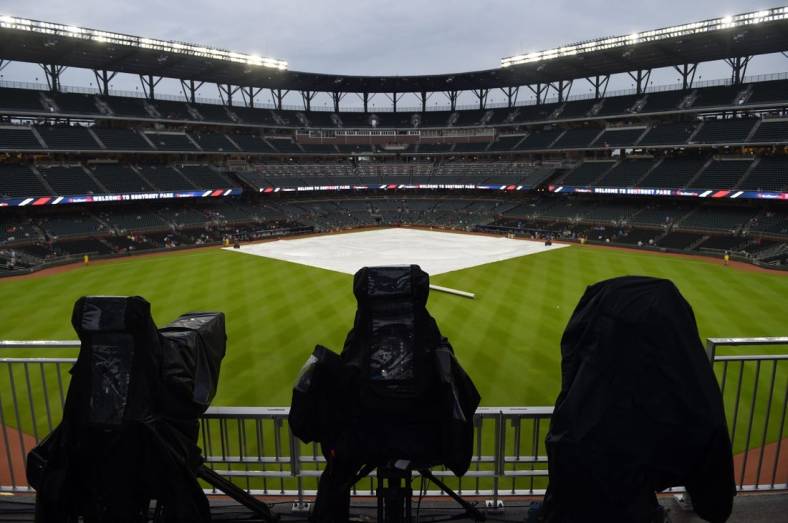 Jul 31, 2018; Atlanta, GA, USA; Television cameras are covered up during a rain delay prior to the game against the Atlanta Braves and the Miami Marlins at SunTrust Park. Mandatory Credit: Adam Hagy-USA TODAY Sports