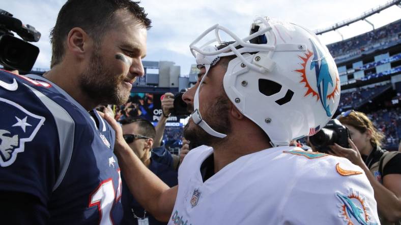 Sep 30, 2018; Foxborough, MA, USA; New England Patriots quarterback Tom Brady (12) and Miami Dolphins wide receiver Danny Amendola (80) meet after the game at Gillette Stadium. The Patriots defeated Miami 38-7. Mandatory Credit: David Butler II-USA TODAY Sports