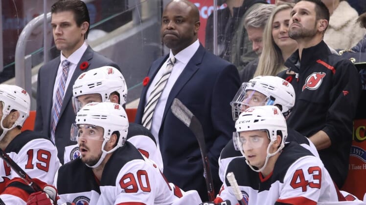 Nov 9, 2018; Toronto, Ontario, CAN; New Jersey Devils assistant coaches Rick Kowalsky and Mike Grier look on from behind the bench as left wing Taylor Hall (9) and left wing Marcus Johansson (90) watch the action against the Toronto Maple Leafs at Scotiabank Arena. The Maple Leafs beat the Devils 6-1. Mandatory Credit: Tom Szczerbowski-USA TODAY Sports