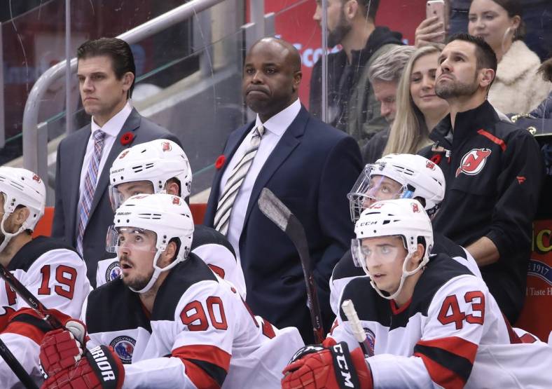 Nov 9, 2018; Toronto, Ontario, CAN; New Jersey Devils assistant coaches Rick Kowalsky and Mike Grier look on from behind the bench as left wing Taylor Hall (9) and left wing Marcus Johansson (90) watch the action against the Toronto Maple Leafs at Scotiabank Arena. The Maple Leafs beat the Devils 6-1. Mandatory Credit: Tom Szczerbowski-USA TODAY Sports