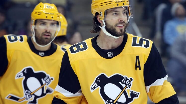 Feb 17, 2019; Pittsburgh, PA, USA;  Pittsburgh Penguins defenseman Kris Letang (58) smiles on the ice against the New York Rangers during the first period at PPG PAINTS Arena. Pittsburgh won 6-5. Mandatory Credit: Charles LeClaire-USA TODAY Sports