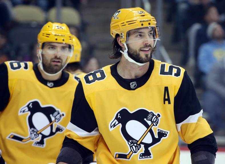 Feb 17, 2019; Pittsburgh, PA, USA;  Pittsburgh Penguins defenseman Kris Letang (58) smiles on the ice against the New York Rangers during the first period at PPG PAINTS Arena. Pittsburgh won 6-5. Mandatory Credit: Charles LeClaire-USA TODAY Sports