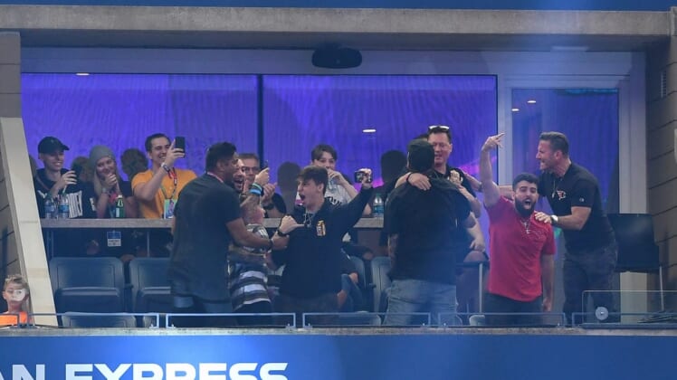 Jul 28, 2019; Flushing, NY, USA; Fans of player Dubs celebrate after his victory in the third round of six at the Fortnite World Cup Finals e-sports event at Arthur Ashe Stadium. Mandatory Credit: Dennis Schneidler-USA TODAY Sports