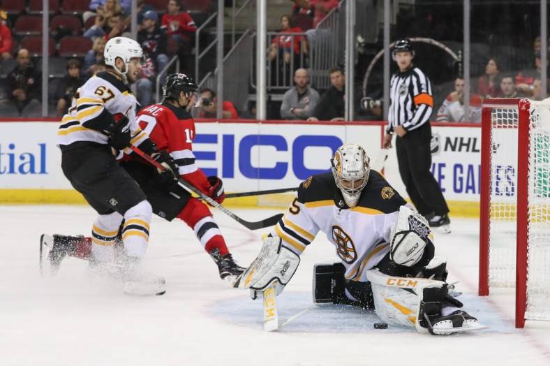 Sep 16, 2019; Newark, NJ, USA; Boston Bruins goaltender Kyle Keyser (85) makes a save on New Jersey Devils center Travis Zajac (19) during the second period at Prudential Center. Mandatory Credit: Ed Mulholland-USA TODAY Sports